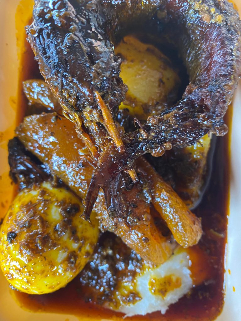 Ewa Agoyin paired with yam, fish, egg, and ponmo